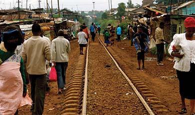 railway tracks in nairobi with people walking either side