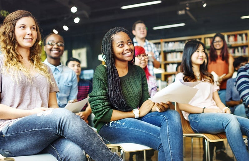 young people listening to talk in library setting