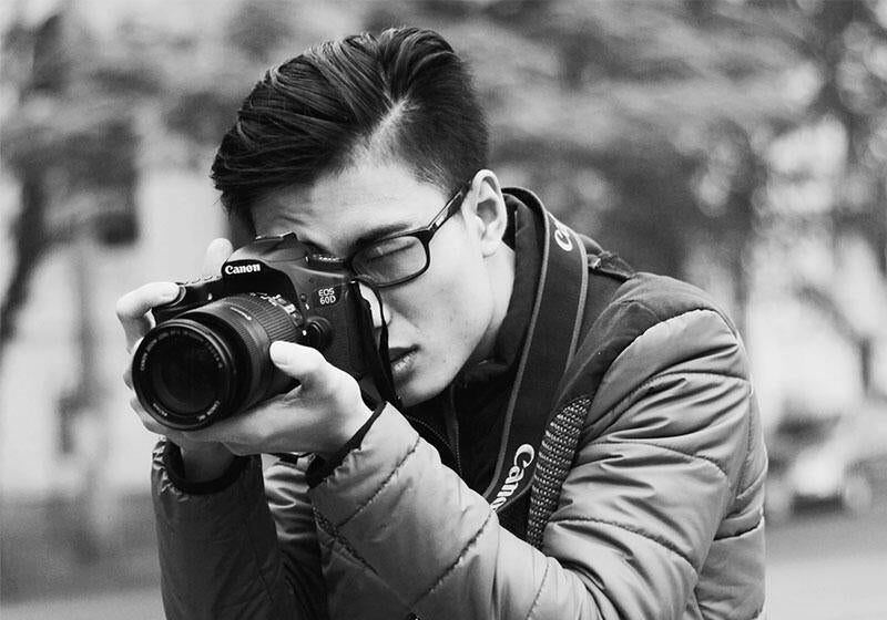 person taking a photograph with camera