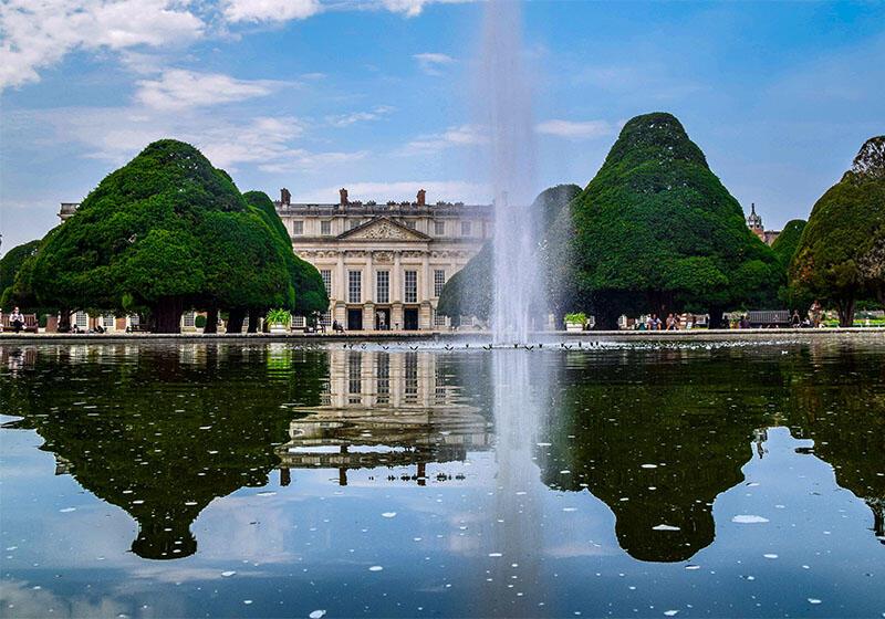 Hampton Court palace, reflected in a lake in the foreground