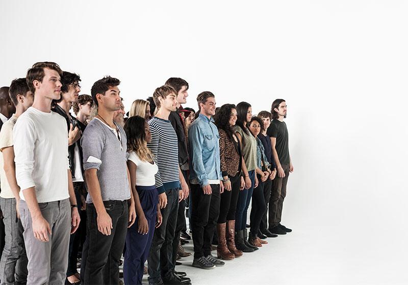 a diverse group of people standing in a line
