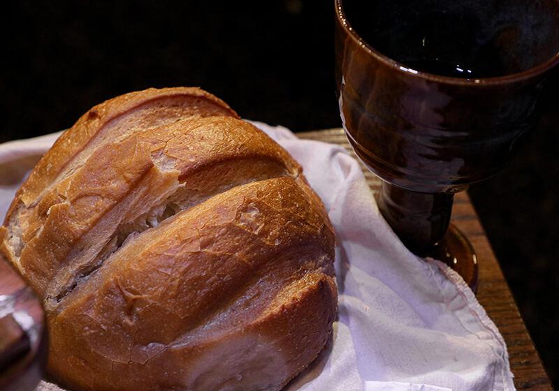a loaf of bread and a glass of wine