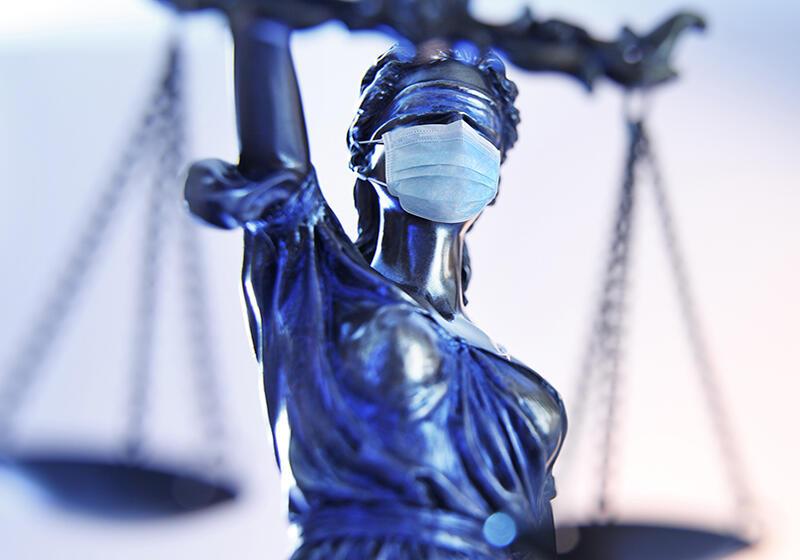 lady justice statue wearing a covid mask