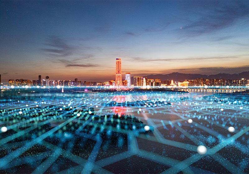 Neon network spreads out towards cityscape at night