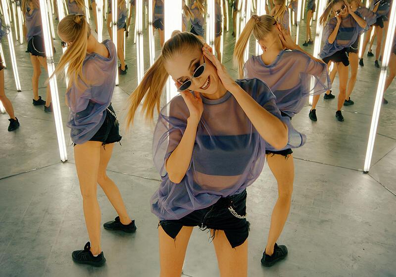 an image of a woman wearing sunglasses dancing