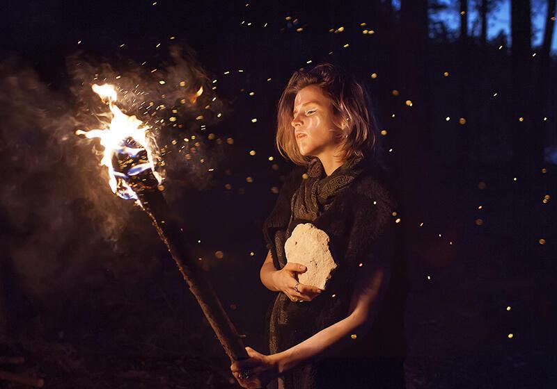 a woman holding a fire torch