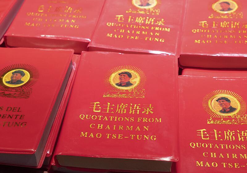 Multiple copies of the red-covered book "Quotations from Chairman Mao Tse-Tung," also known as the Little Red Book, with a portrait of Mao Tse-Tung on the front cover