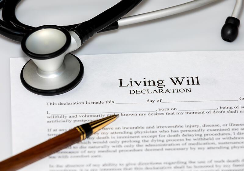 A living will document with a stethoscope and a pen on top