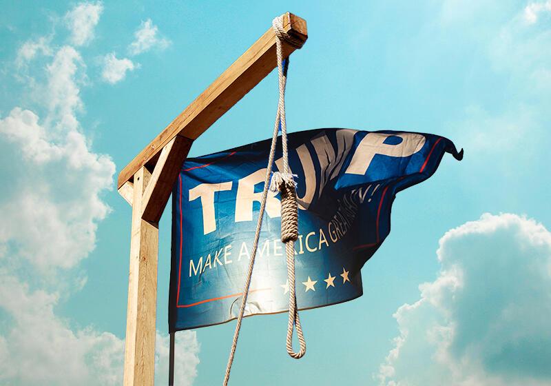 A "TRUMP MAKE AMERICA GREAT AGAIN!" flag hanging from a wooden gallows with a noose