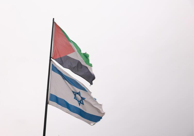 Palestine and Israel flgas flying on the same pole