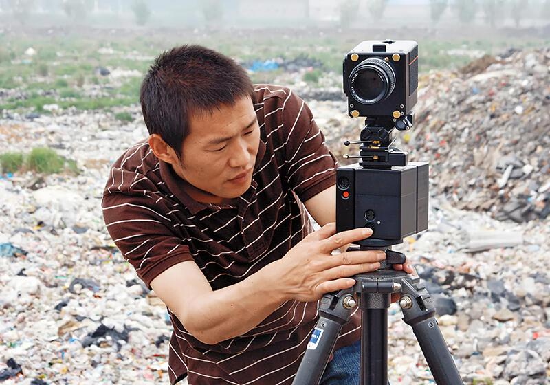 Chinese filmaker setting up video camera