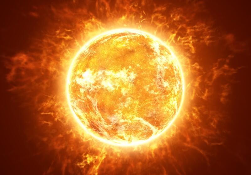 An artist's impression of the Sun, depicted as a glowing, bright orange and yellow sphere covered in turbulent solar flares and surrounded by an intense, fiery corona radiating into space