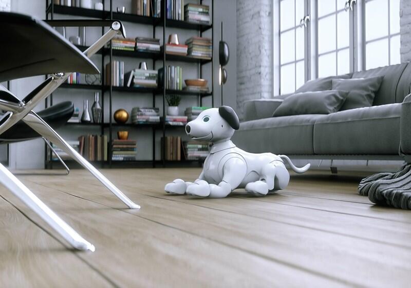 A white and black robotic companion dog lies on a light-coloured wooden floor in the centre of a modern, minimalist living room