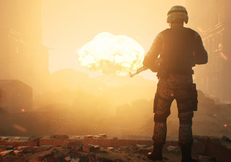 A soldier in digital camouflage uniform stands with their back to the viewer, holding a rifle and looking out over a ruined, hazy city landscape where a large explosion flares in the distance under an orange sky