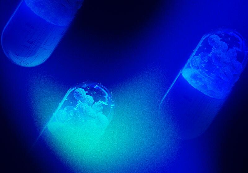 Neon pill capsule with technology sumbols and brains floating inside