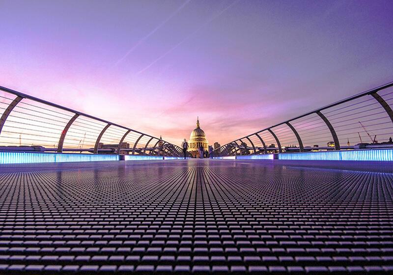 view across the Millenium Bridge towards St Pauls at dusk