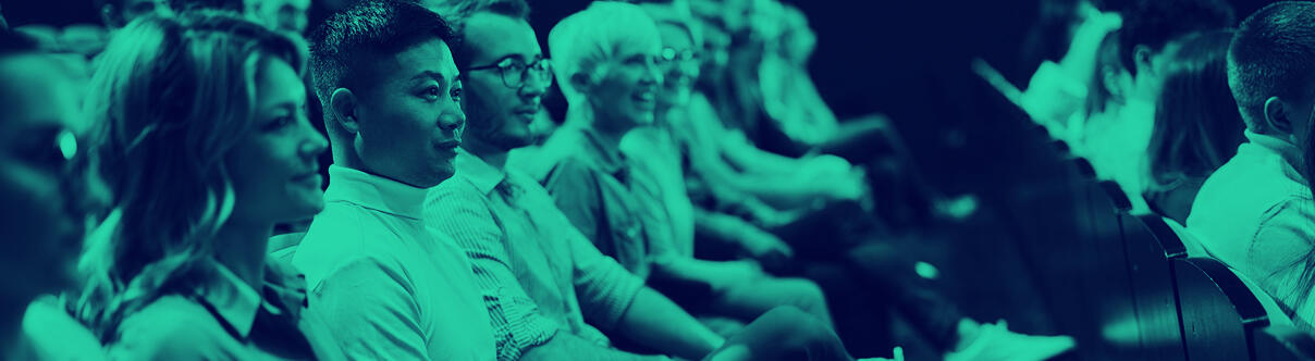 Group of people in audience watching something