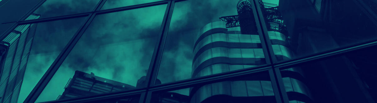 Cityscape reflected in glass facade