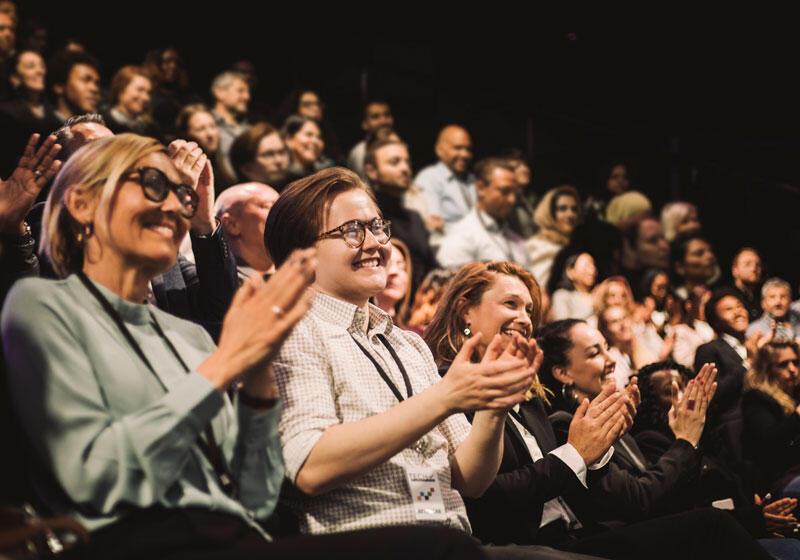 Audience smiling and clapping