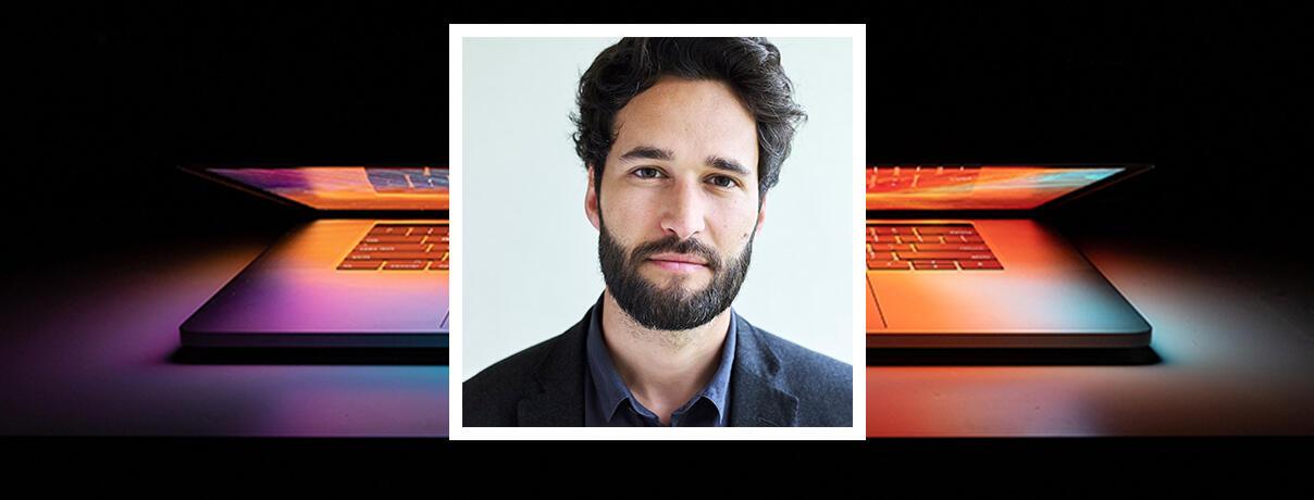 Professor Daniel Susskind on backgroun showing a laptop computer