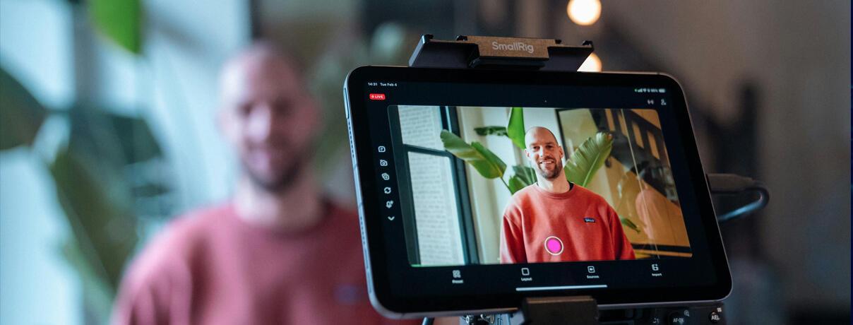 Behind camera shot of young man smiling while being interviewed