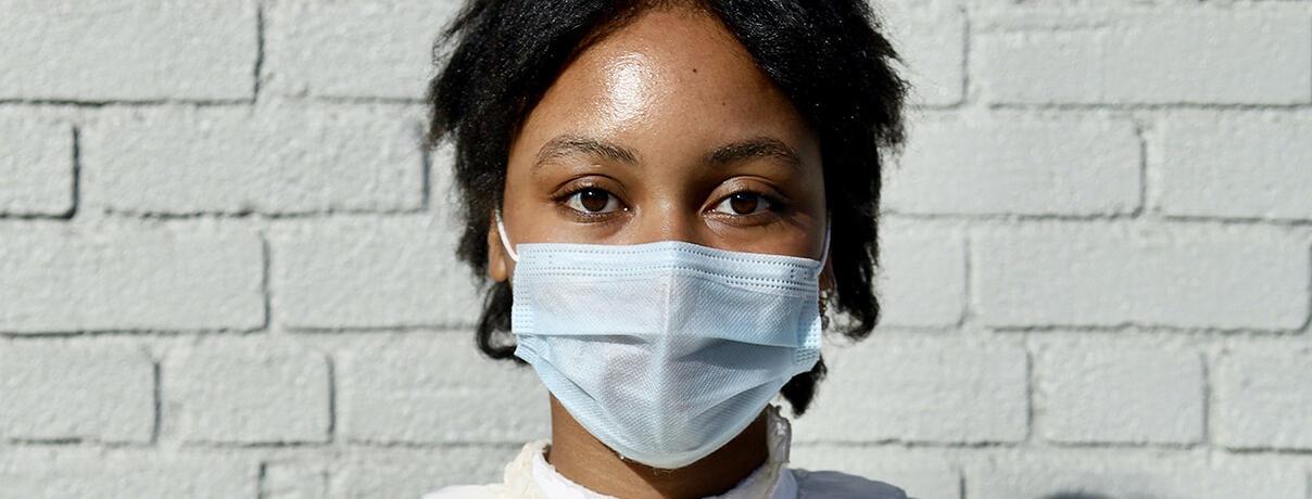 close up of face of black lady wearing mask