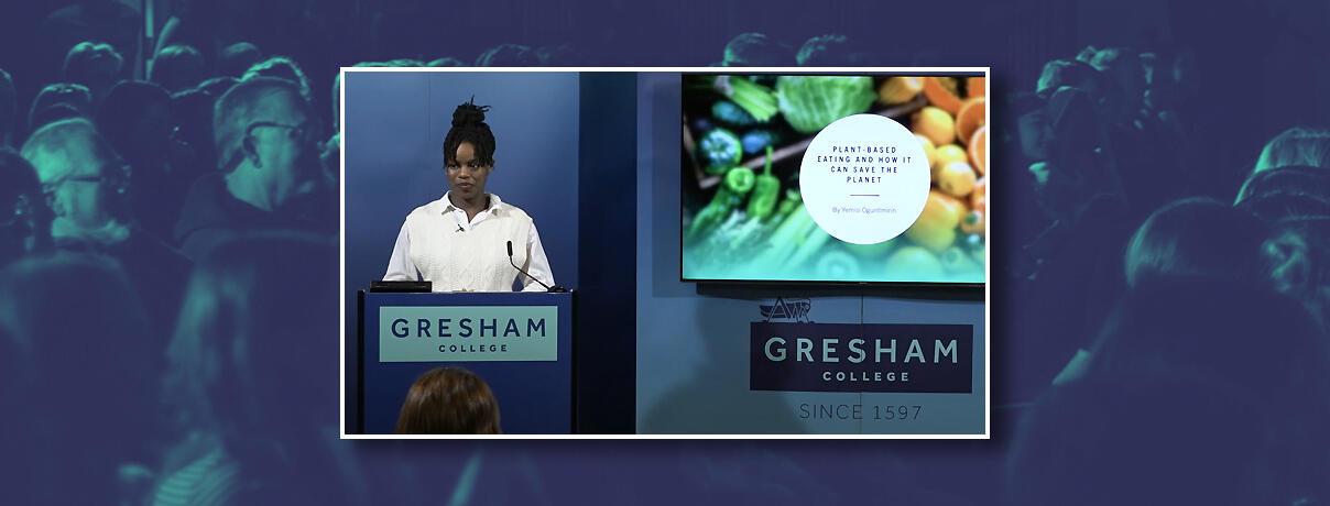 Picture of the winner of the first Gresham College Oracy Competition speaking at podium