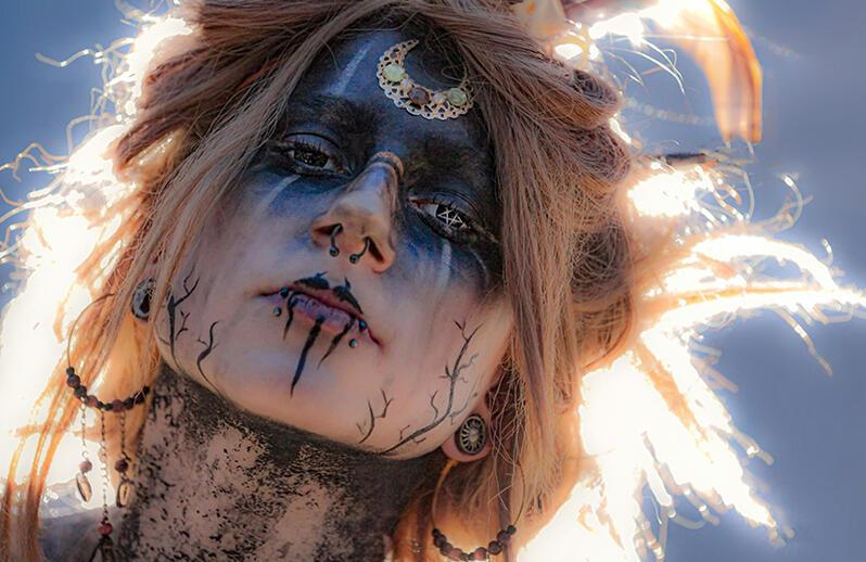 Stylised blue-green photos of a monk, a pixellated dog, a close-up spore, a person on a hill, a toy robot and a banana wrapped in chains