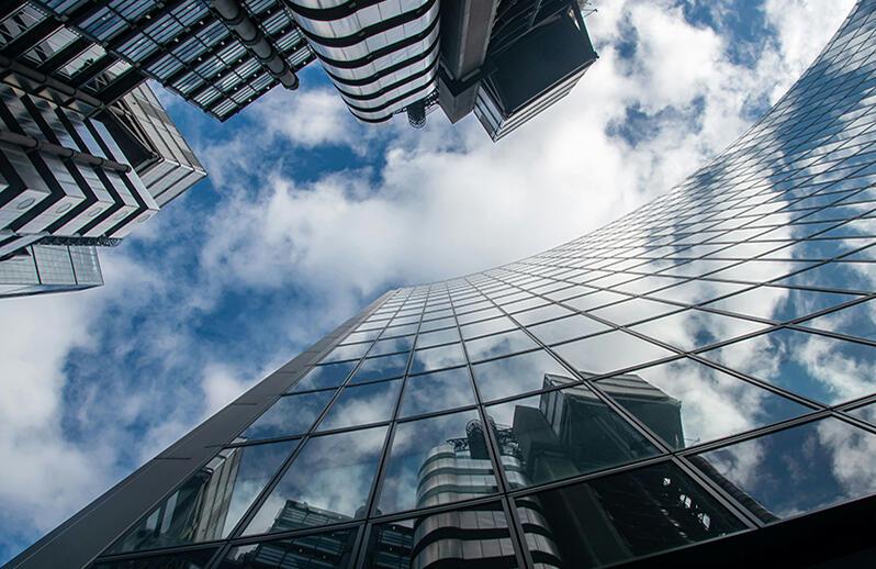 Cityscape reflected in glass facade