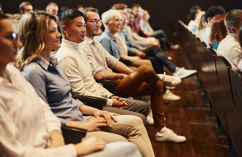 Group of people in audience watching something