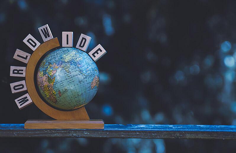close up of globe with letters spelling world wide above