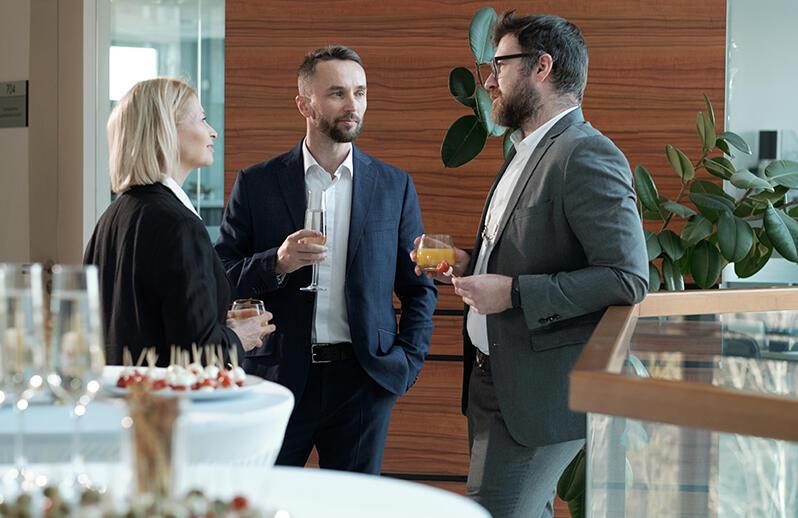 Three professionals in suits talking