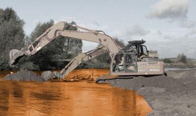Mechanical diggers at work on river bank