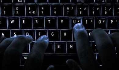 Fingers typing on keyboard