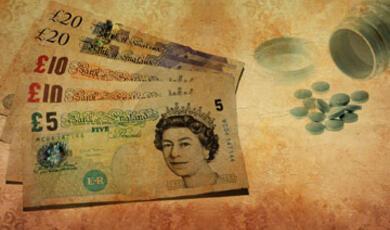 British pound banknotes (including £5, £10, and £20 notes) alongside a spilled bottle of pills