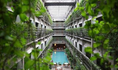 Vertical farm with multiple tiers of green plants and a water channel