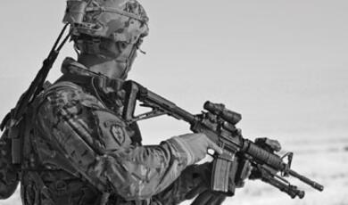 Black and white photograph of soldier holding a gun