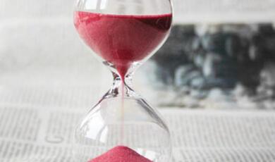 An hourglass with red sand