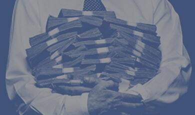 Man in suit holding a pile of money
