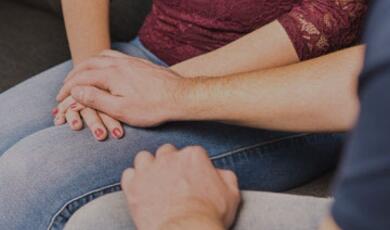 One person holding another's hands