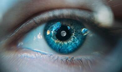 a human eye with the moon in the pupil