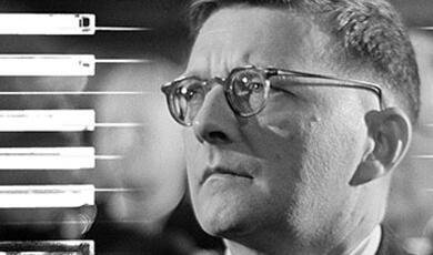 Black and white photograph of Shostakovich  with piano keys detail background