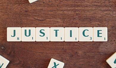 Scrabble tiles spelling out the word justice