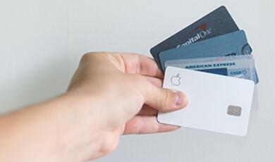 hand holding several bank cards
