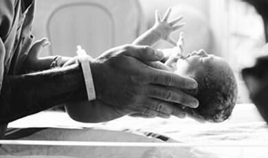 person holding a newborn baby