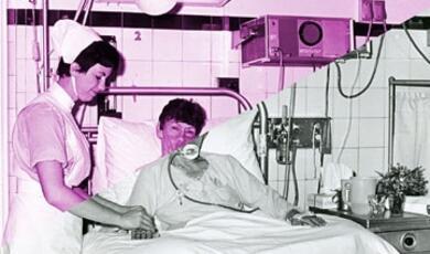 Nurse with patient in bed