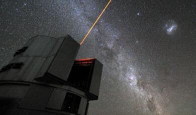 a large astronomical observatory in the foreground firing a laser beam into space, with the background of the stars of the milky way