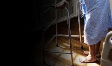 An older person using a walker