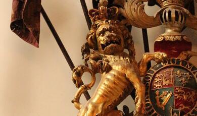 photograph of lion on a crest
