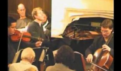 Still of Gresham audience and musicians at the lecture